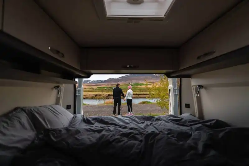 Couple outside a small RV